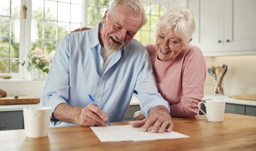 Older couple signing a paper